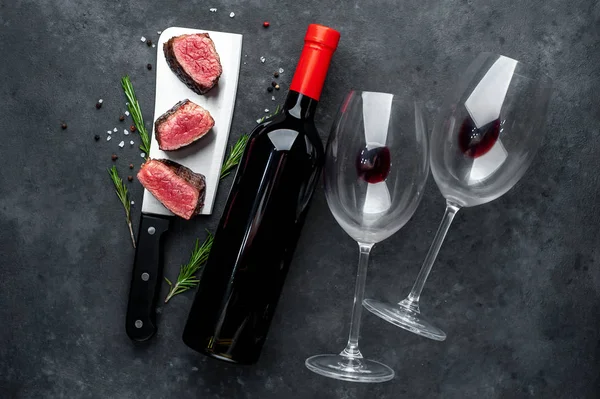 delicious steak and wine on a stone background
