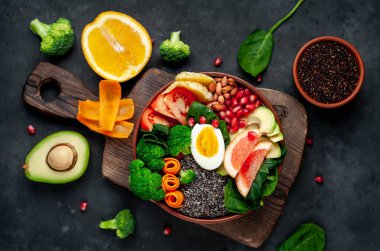 Lezzetli taze meyve suyu sebzeli kase ve sebzeli meyve ve tahıllı tahtalar kırsal masa arka planında.