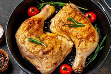 İştah açıcı kızarmış tavuk budu, siyah tavada.