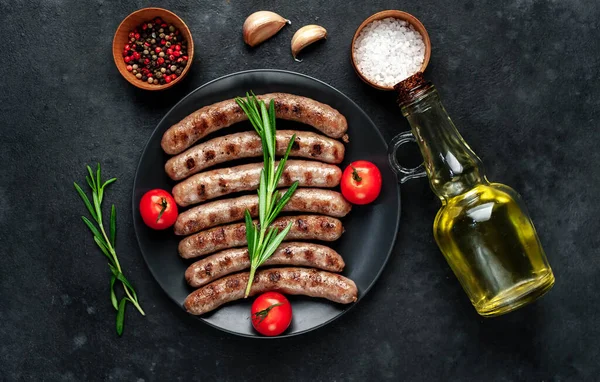 Grilled Sausages Plate Garlic Rosemary Tomatoes Olive Oil Bottle Barbecue — Stock Photo, Image
