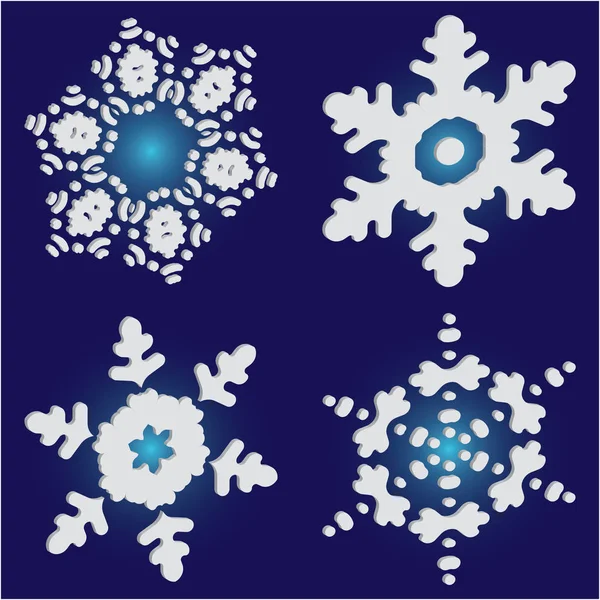 Mavi zemin üzerinde izole kar taneleri kesilmiş kağıt koleksiyonu. 