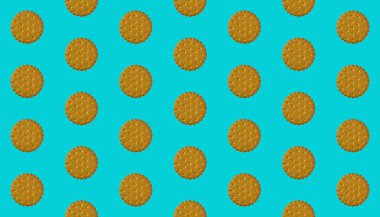 Turkuaz arka planda ritmik desenli yuvarlak kurabiyeler