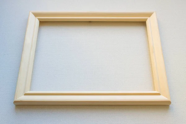 Wooden frame on white canvas