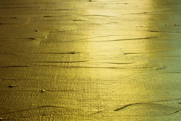 Background-rough art canvas painted with gold paint close-up with copy space