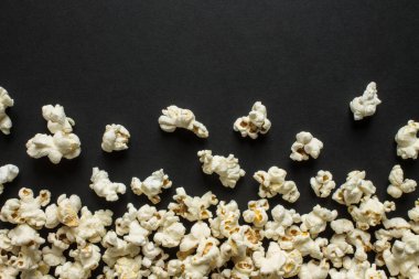 Çerçeve patlamış mısırı siyah bir arka plana serpiştirip boşluğu kopyalamak