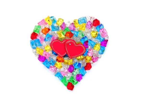 Heart shape made of colored transparent stones — Stock Photo, Image