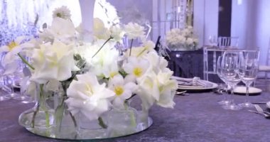 A Festive Table Decorated With White Flowers 