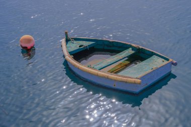 old boat filled with water is lying in a small harbor of Arrecife, Lanzarote clipart