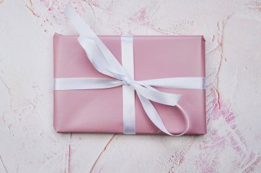 pink present in the middle of a pink structured background