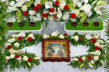 Orlovshchina, Ukrayna, Ortodoks Kilisesi, 04.28.2019. Hz. İsa 'nın ikonu taze çiçeklerle çevrili mezarda yatıyor. Yukarıdan Paskalya Manzarası 'nın kutlanması için tapınağın dekorasyonu..
