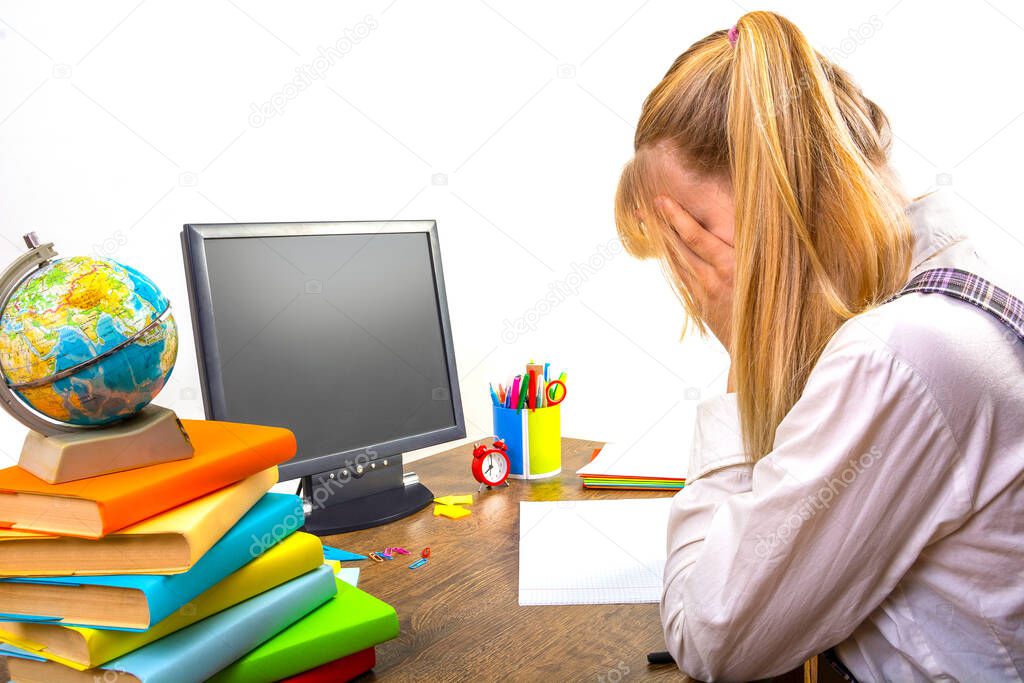 School online, learning at home, high school student crying, covering her face with her hands. School subjects are not assimilated when watching and listening to online lessons. Mock up monitor, side view, place for text, Copy space.