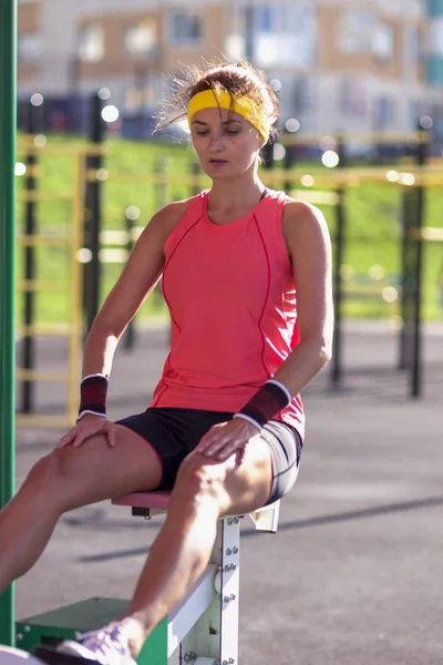 Portrait of Concentrated Caucasian Female Athlete in Professional Training Outfit Having Outdoor Workout Exercises