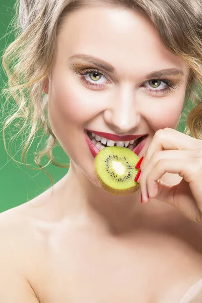 Closeup of Sensual and Sexy Naked Caucasian Model with Teeth Diastema Posing With Juicy Kiwi Fruit.