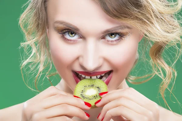 Sensual and Sexy Naked Caucasian Model with Teeth Diastema Posing With Juicy Kiwi Fruit