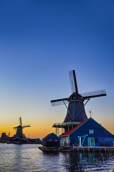 Dutch Travel Concepts. Two Traditional Dutch Windmills in the Village of Zaanse Schans at Daytime in the Netherlands. Vertical Image