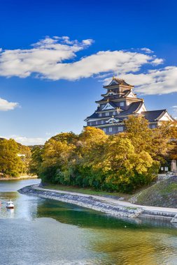 Okayama Karga Kalesi ya da Japonya 'daki Asahi Nehri' ndeki Okayama City 'deki Ujo Kalesi. Öndeki Küçük Tekne 'yle. Dikey Çekim