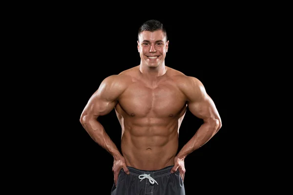 Homens musculares músculos flexantes em fundo preto — Fotografia de Stock