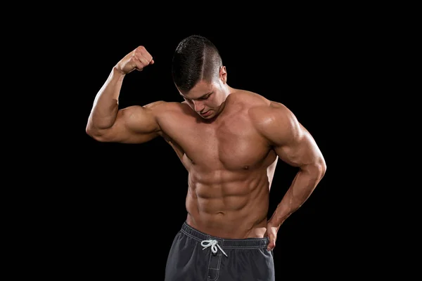 Muscular Men Flexing Muscles On Black Background — Stock Photo, Image