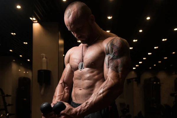 Muskulös Man tränar Biceps på kabel maskin — Stockfoto