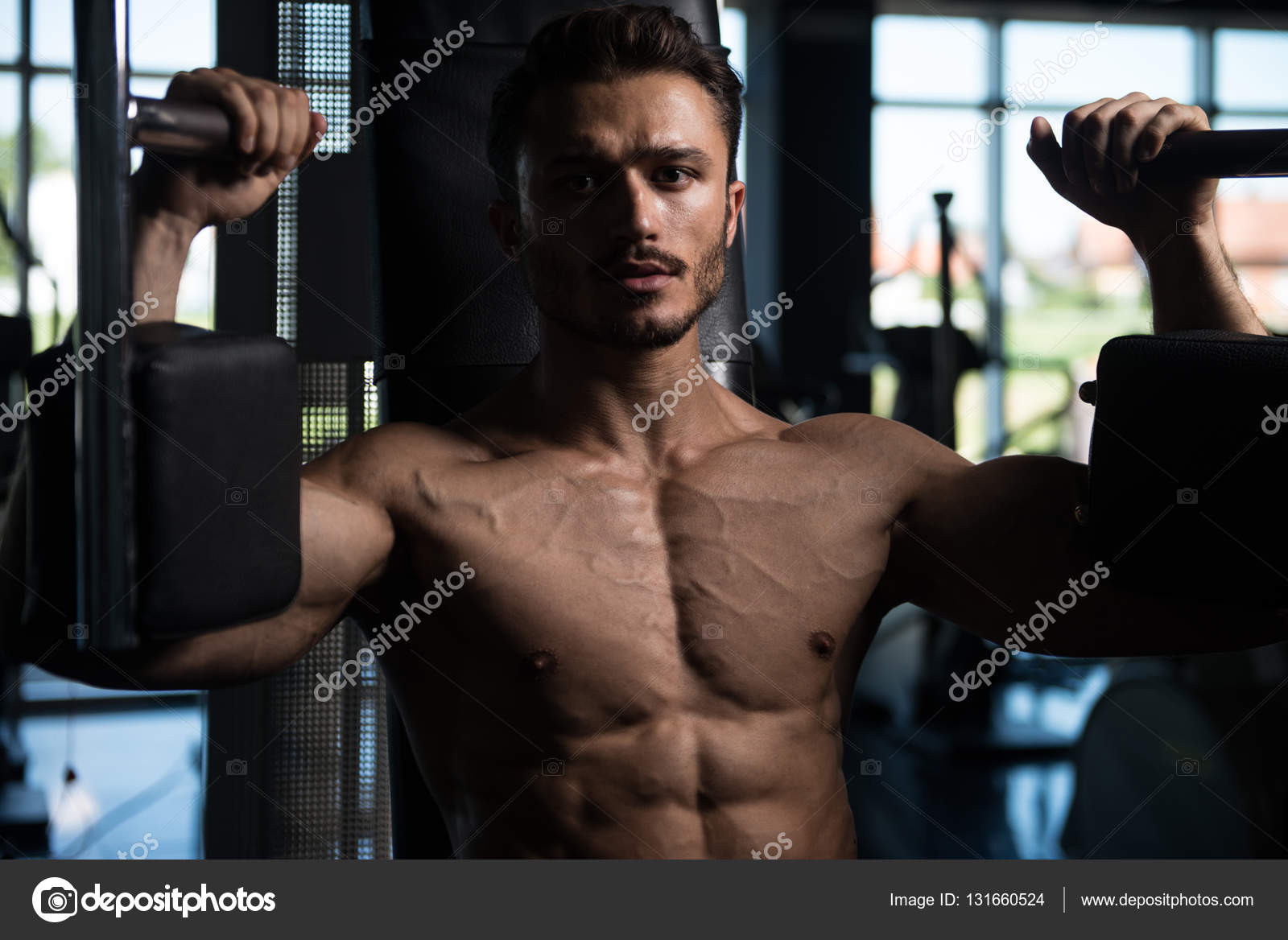 Man Doing Butterfly Chest Exercise On Machine Stock Photo by ©ibrak