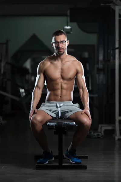 Attractive Young Geek Resting In Gym Afther Exercise