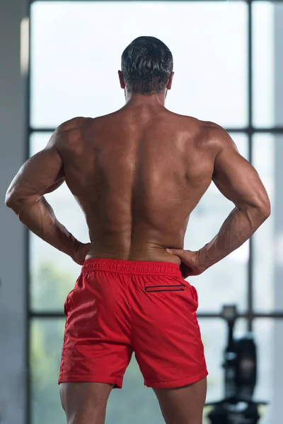 Young Bodybuilder Flexing Back Pose — Stock Photo, Image