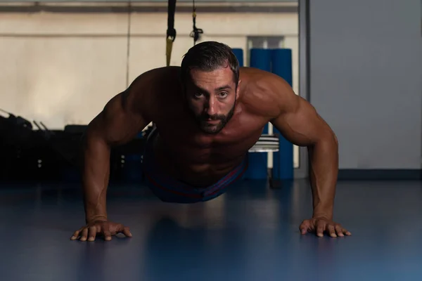 Homem fazendo imprensa com correias Trx Fitness — Fotografia de Stock