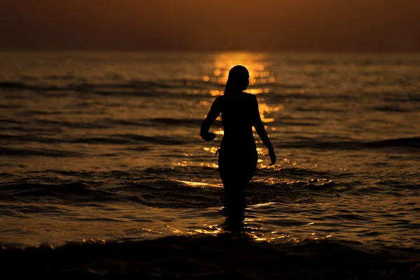Woman on the Beautiful Beach at Sunrise Stock Photo