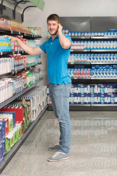 Confundido hombre de compras en el supermercado —  Fotos de Stock