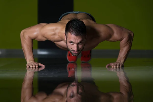 Muscular Man Exercising Push Ups On Floor