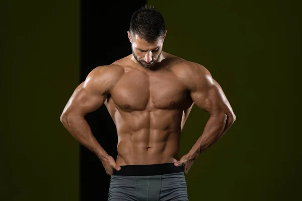 Young Bodybuilder Flexing Muscles Stock Photo