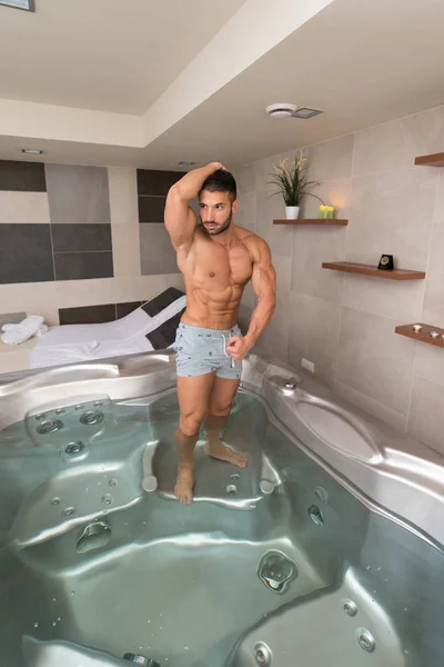 Flexing Muscles in Hot Tube Jacuzzi