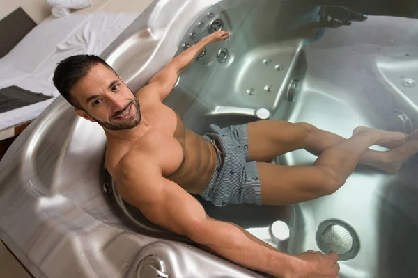 Guy Lying in Azure Jacuzzi — Stock Photo, Image