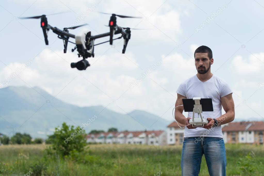 Man Operating a Flying Drone in the Sky