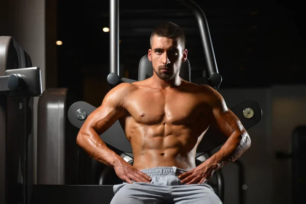 Hombre descansa en el gimnasio después de hacer un entrenamiento — Foto de Stock