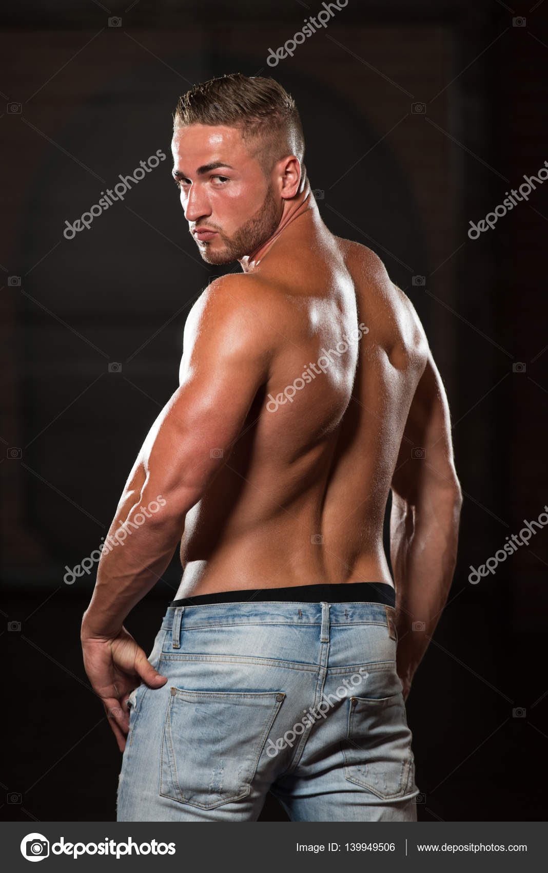 Young Bodybuilder In Jeans Flexing Muscles ⬇ Stock Photo, Image by