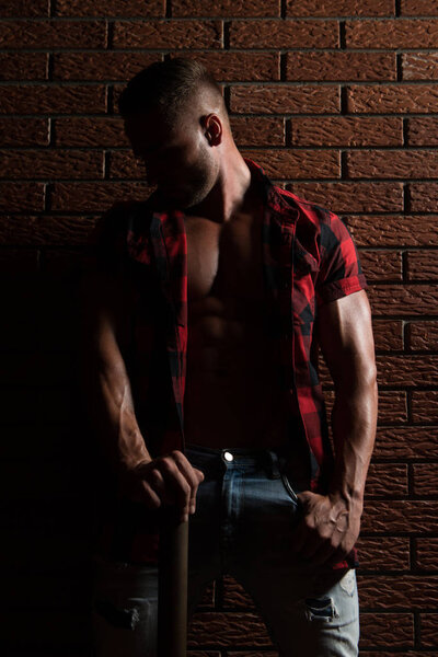Man Standing Strong On Wall of Bricks