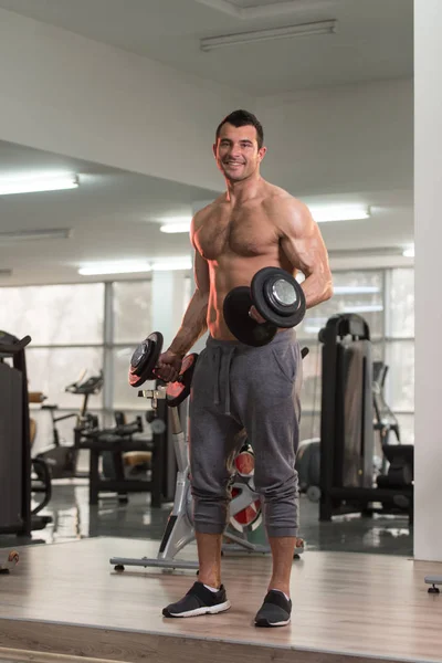 Biceps Exercise With Dumbbell in a Gym — Stock Photo, Image