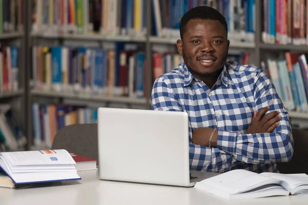 Happy African Male Student With Laptop In Library — Stock Photo, Image