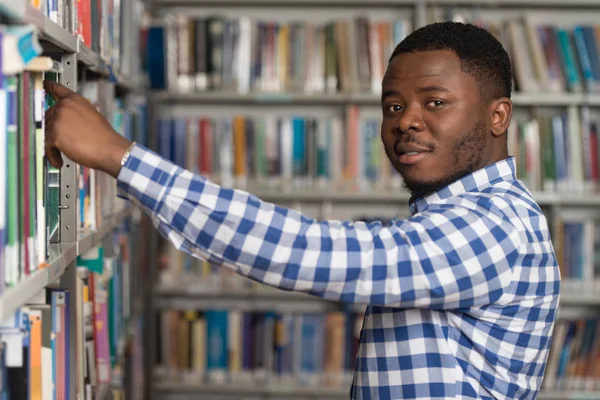 Mužský College Student v knihovně — Stock fotografie
