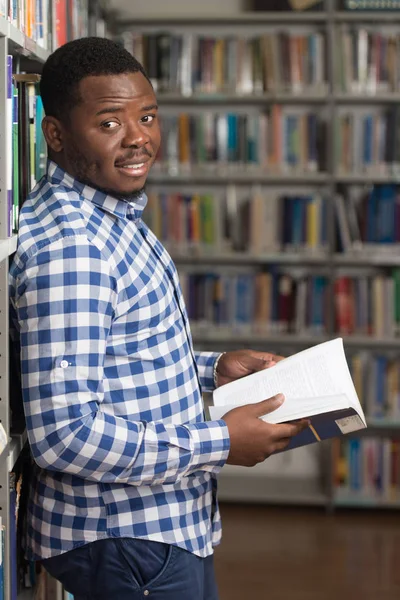 Pohledný mladý vysokoškolský Student v knihovně — Stock fotografie