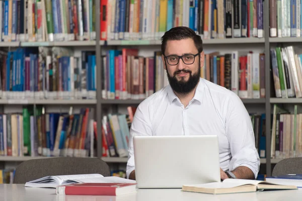 Young Student Using His Laptop In A Library — Stock Photo, Image