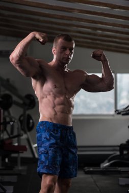 Vücut geliştirmeci Fitness Model çifte kol kası egzersizleri sonra poz