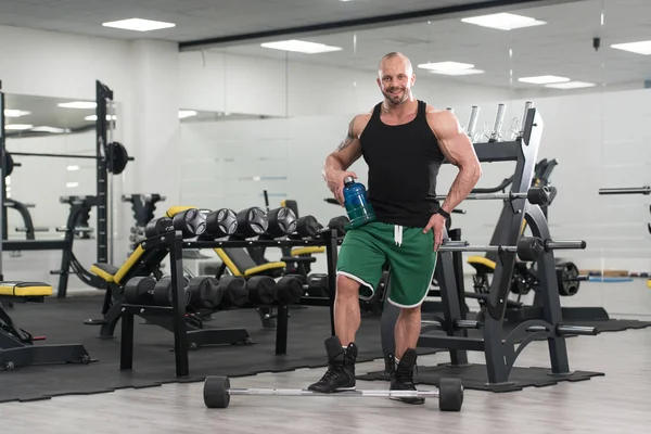 Fisiculturista posando com suplementos para espaço de cópia — Fotografia de Stock