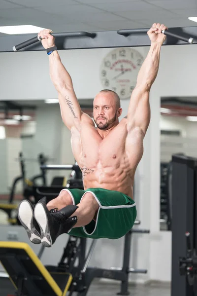 Young Man Performing Hanging Leg Raises Exercise — Stock Photo, Image