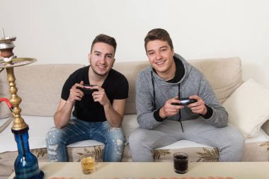 Two Friends Playing Video Games clipart