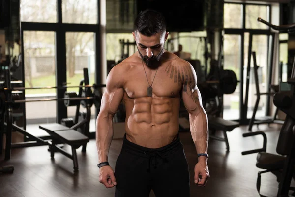 Attractive Young Man Resting In Gym Afther Exercise