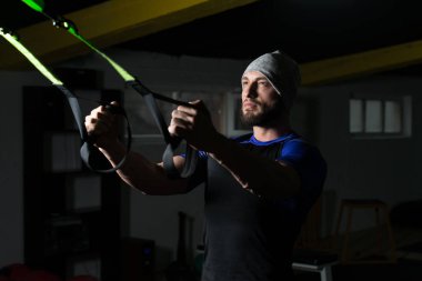 Trx Fitness askıları ile çekici bir adam eğitim