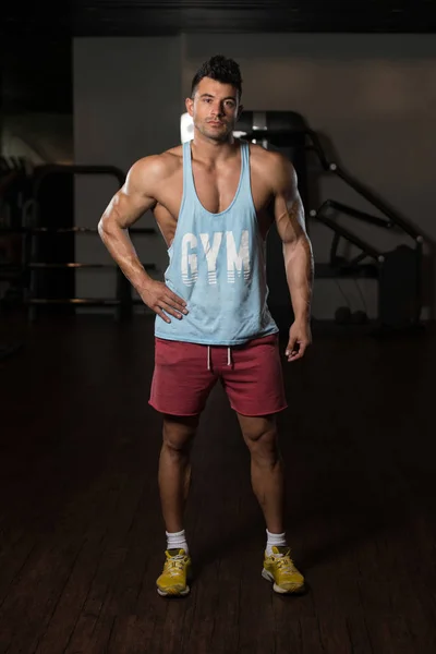 Fitness Model In Undershirt Flexing Muscles — Stock Photo, Image