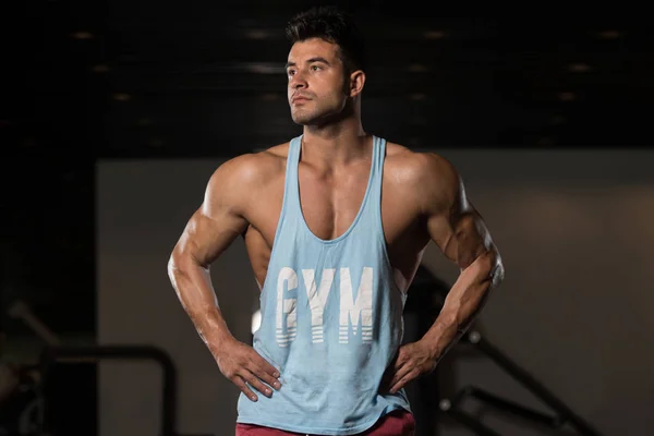 Fitness Model In Undershirt Flexing Muscles — Stock Photo, Image